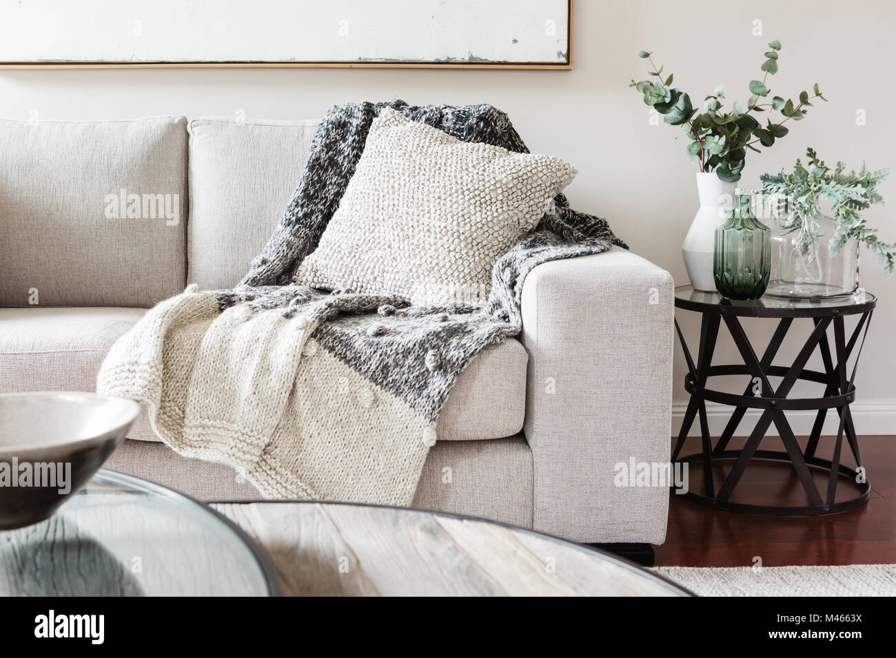 Textured layers interior styling of cushion sofa dn throw in nuetral colors Stock Photo