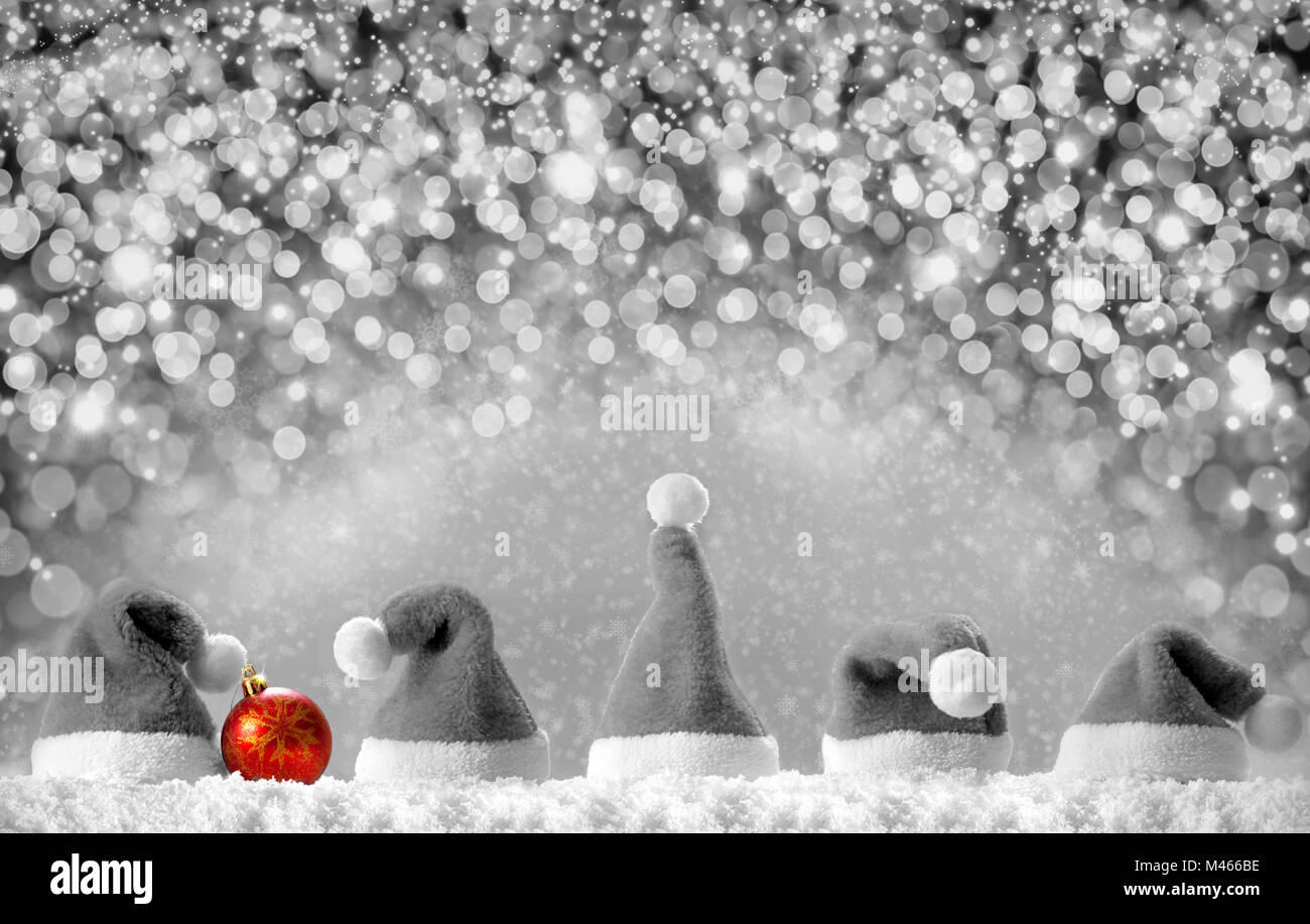 Red Santa hats isolated on silver  bokeh background. Stock Photo