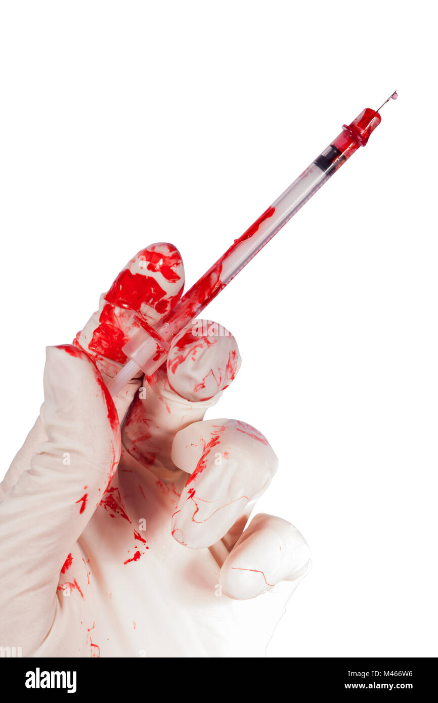 Bloody gloved hand holding a syringe Stock Photo