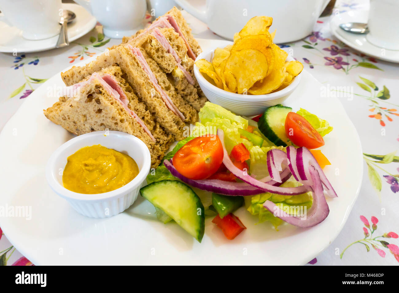 CafÃ© lunch a ham sandwich in granary bread with salad crisps and