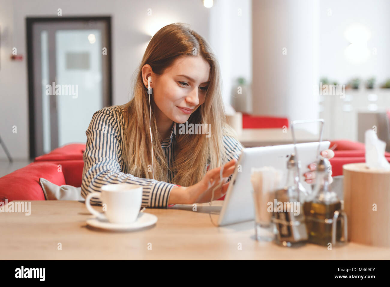 Young gorgeous woman wathing video online at the cafe Stock Photo