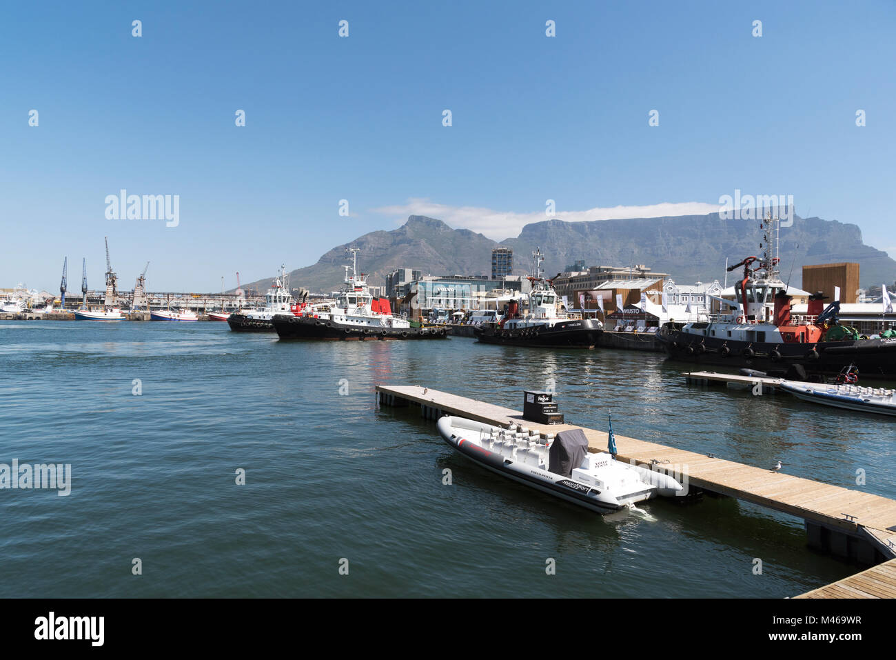 Ocean going tugs alongside on Cape Town harbour with a backdrop of Table Mountain, South Africa, Stock Photo