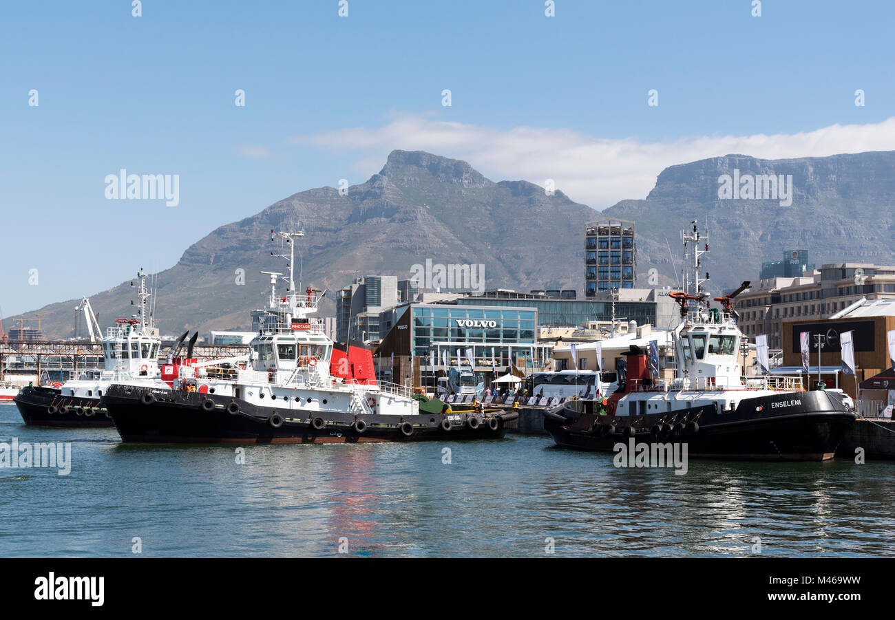 Ocean going tugs alongside on Cape Town harbour with a backdrop of Table Mountain, South Africa, Stock Photo