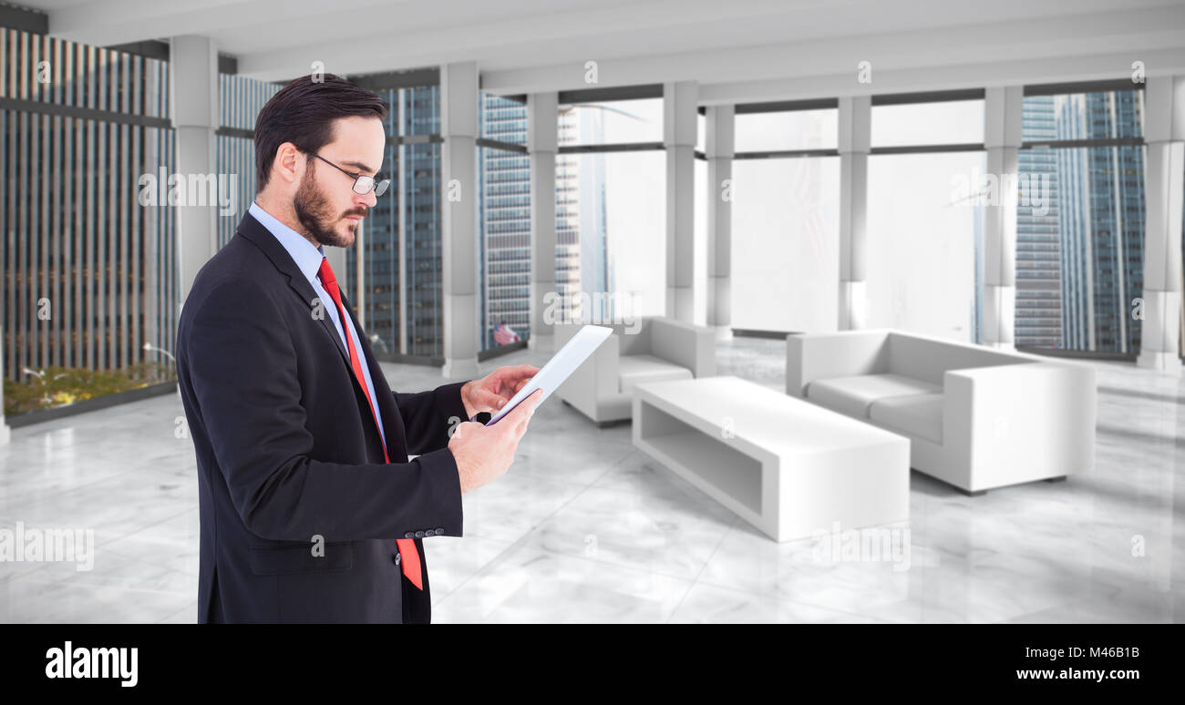 Composite image of businessman scrolling on his digital tablet Stock Photo