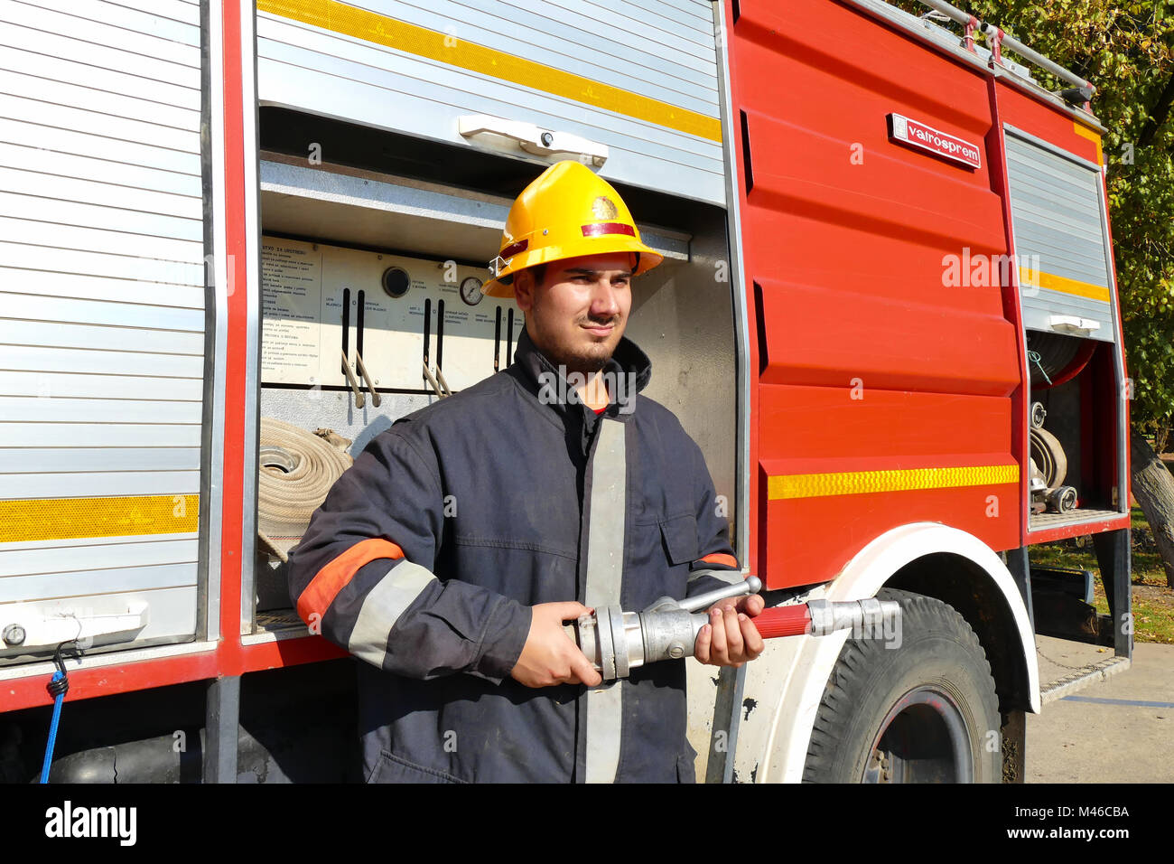 Firefighter With A Hose Stock Photo - Alamy