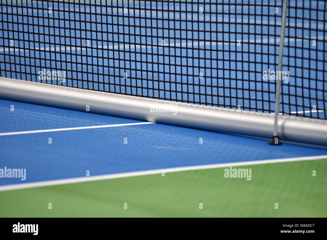 Tennis blue hard court with net before competition Stock Photo
