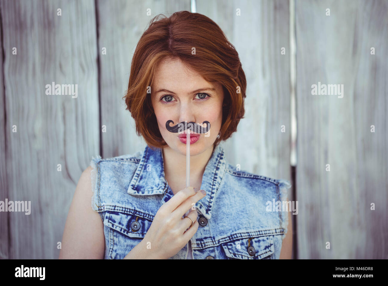 Woman holding fake mustache hi-res stock photography and images - Alamy