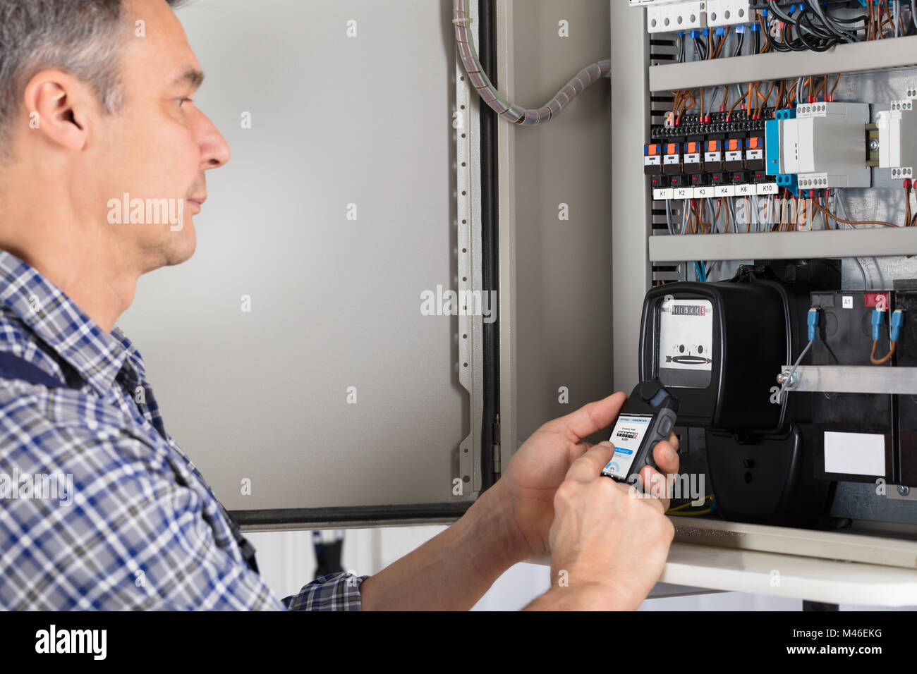 Close-up Of A Male Technician Doing Meter Reading Stock Photo