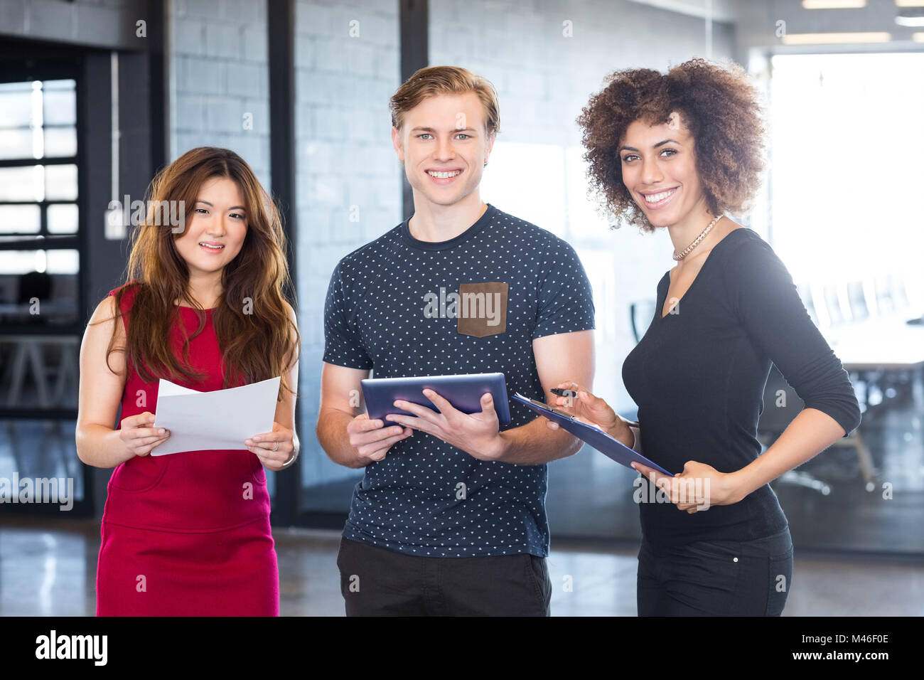 Portrait of business executives standing together in office Stock Photo ...