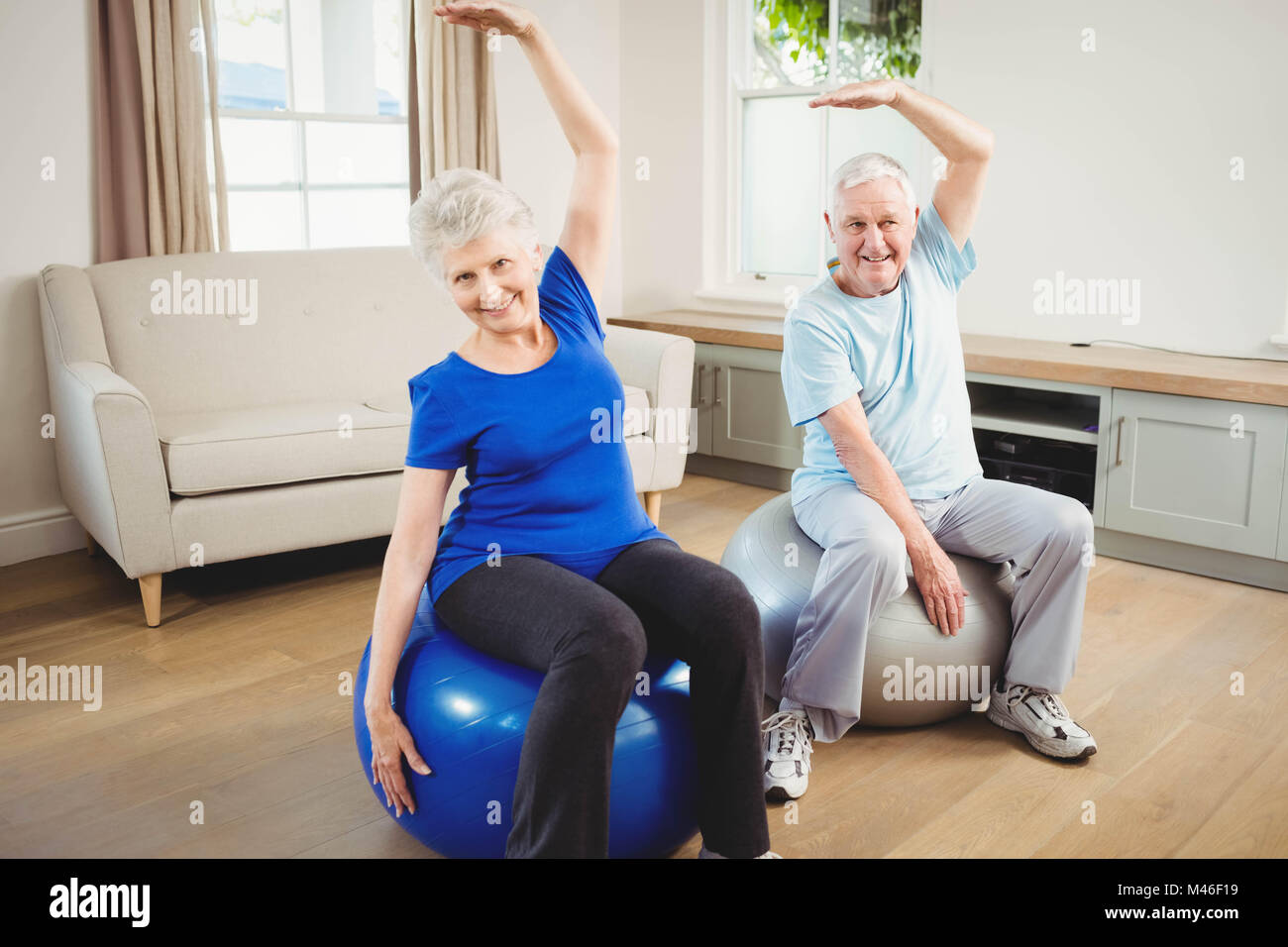 Senior couple doing stretching exercise on exercise ball Stock Photo ...