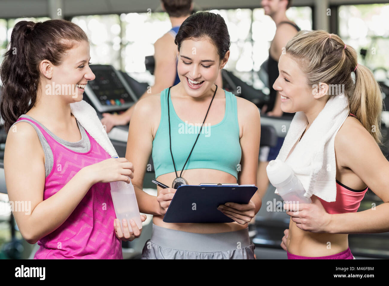 Athletic smiling women discussing about performance Stock Photo - Alamy