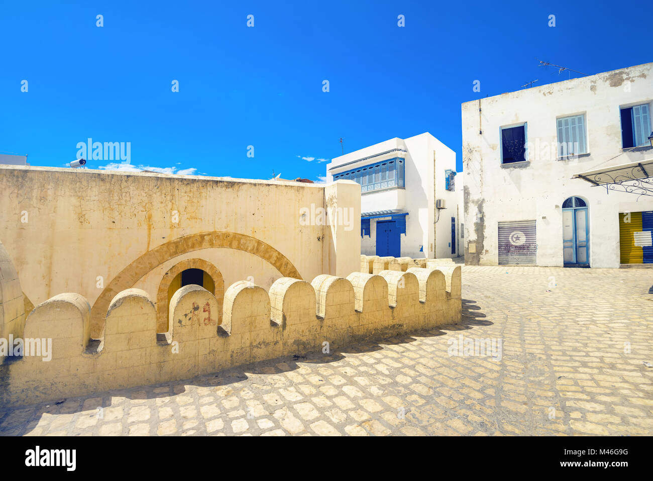 Street scene with part of fortress wall and white houses in Sousse. Tunisia, North Africa Stock Photo