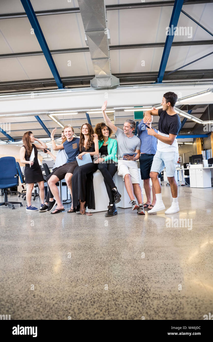 Group of businesspeople interacting during break time Stock Photo - Alamy