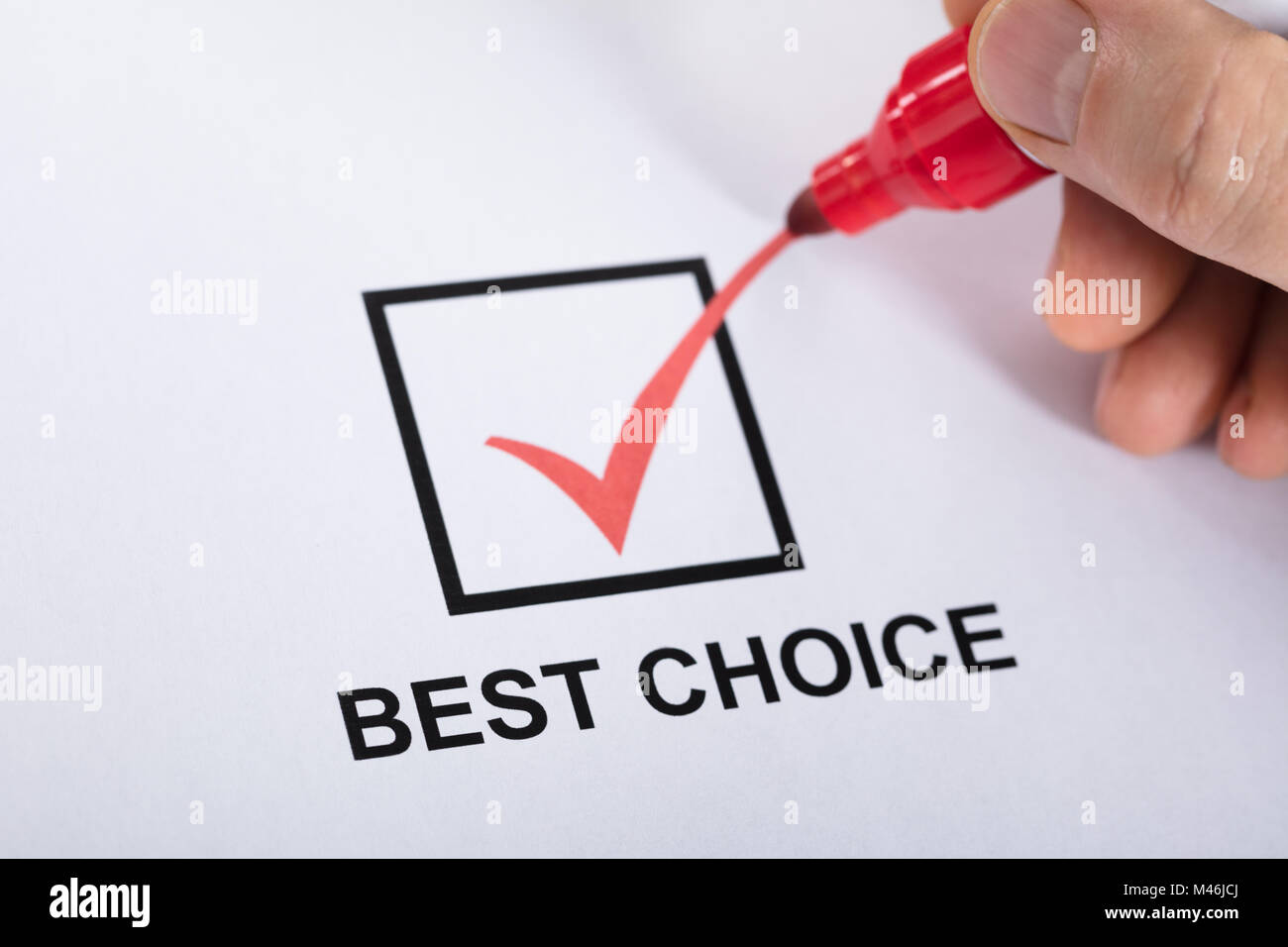 Close-up Of A Person Hand Ticking Best Choice In Check Box Option Using Red Marker Stock Photo