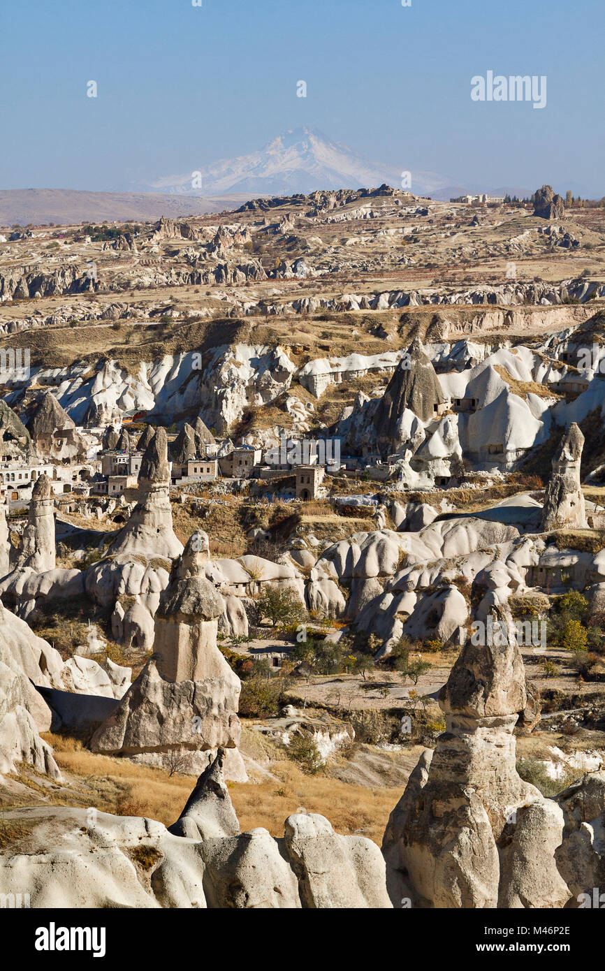 Volcanic rock formations known as Fairy Chimneys with Volcano Erciyes in the background, Turkey. Stock Photo