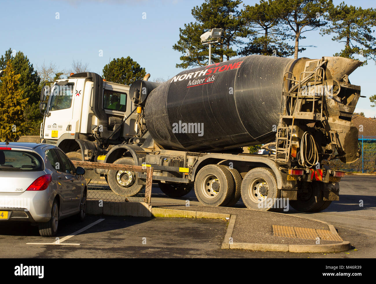 A heavy duty ready mix concrete delivery lorry negotiating a difficult sharp bend on the Bloomfield Road in Bangor County Down Northern Ireland Stock Photo