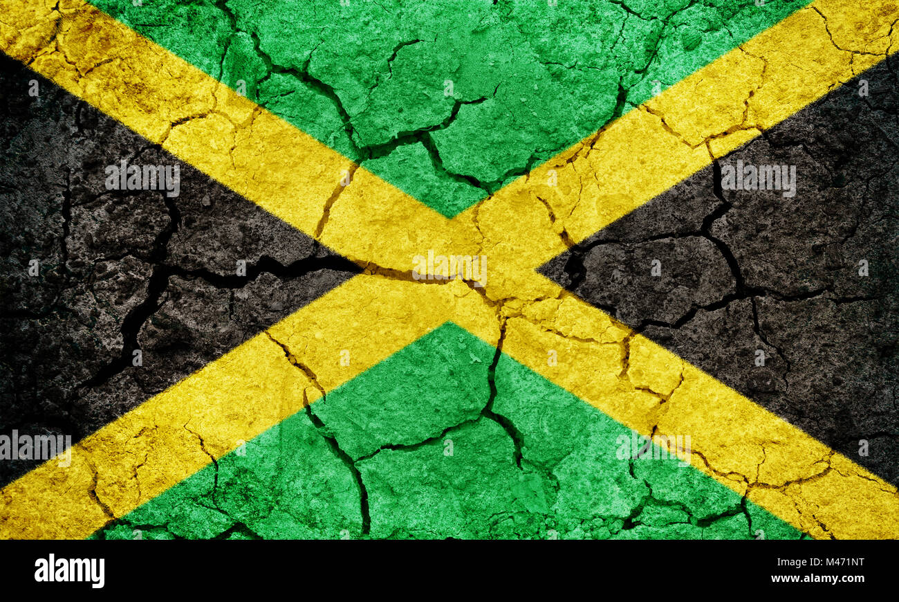 Jamaica flag on dry earth ground texture background Stock Photo - Alamy
