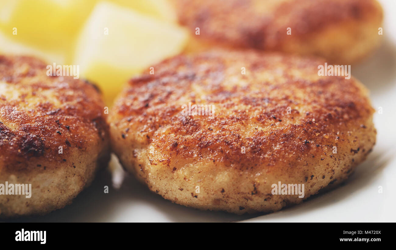 prepared fried fish cakes with boiled potatoes Stock Photo - Alamy