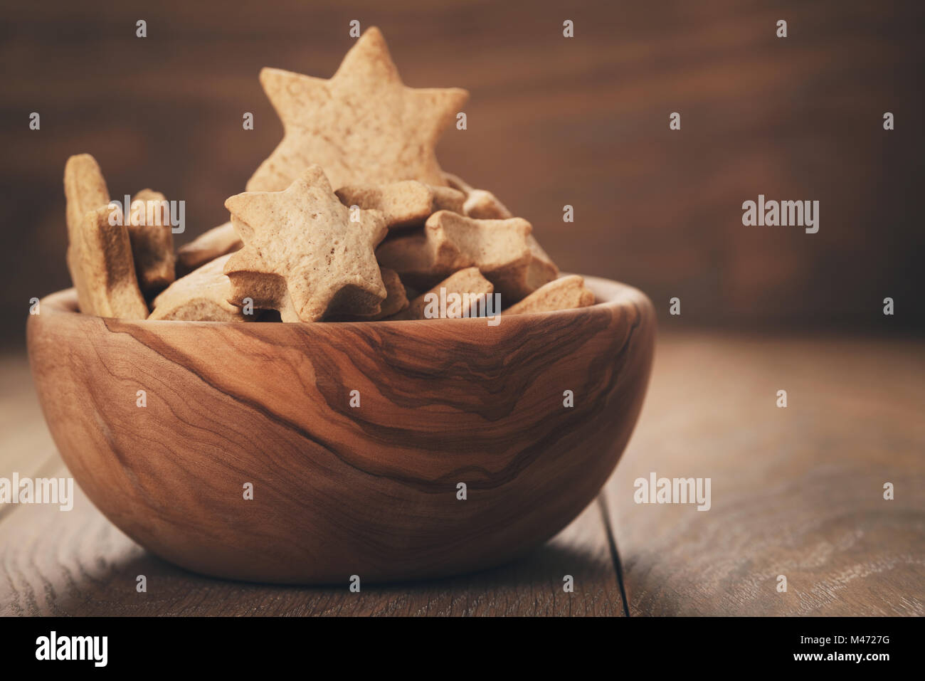 homemade star cookies for christmas in bowl on wood table Stock Photo