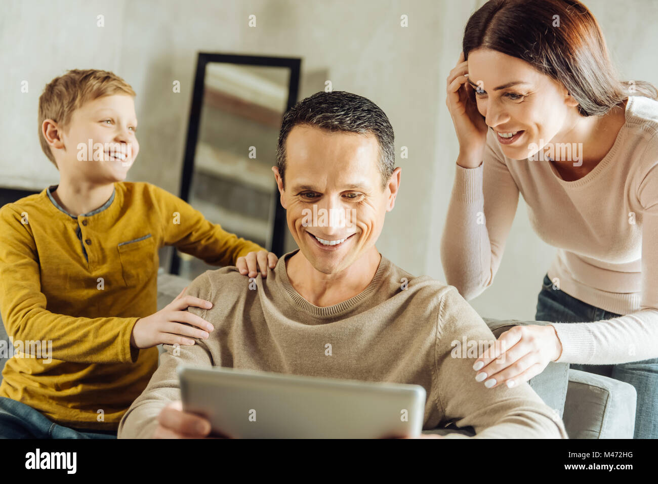 Mother and son watching video together with father Stock Photo - Alamy