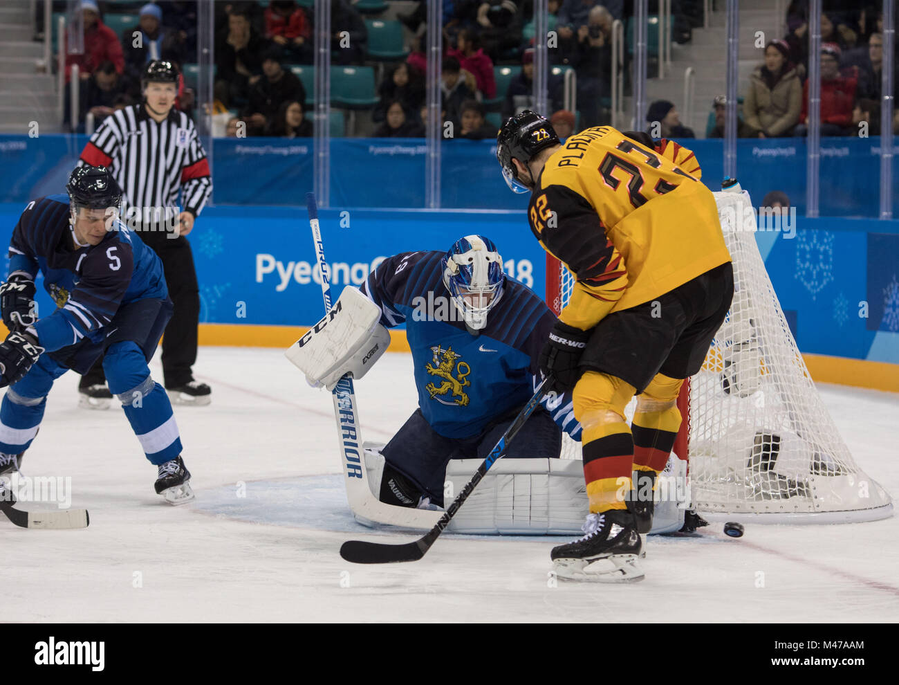 Gangneung, South Korea. 14th Feb, 2018. Finland goalkeeper MIKKO KOSKINEN makes a save against MATTHIAS PLACHTA of Germany during Ice Hockey: Men's Preliminary Round - Group C at Gangneung Hockey Centre during the 2018 Pyeongchang Winter Olympic Games. Credit: Mark Avery/ZUMA Wire/Alamy Live News Stock Photo