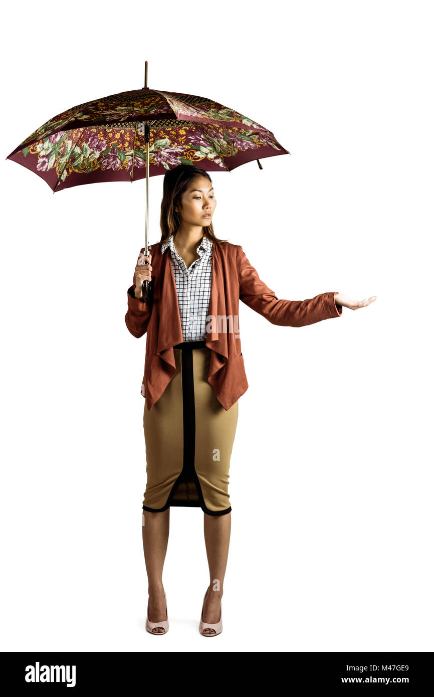 Businesswoman with an umbrella feeling the rain Stock Photo