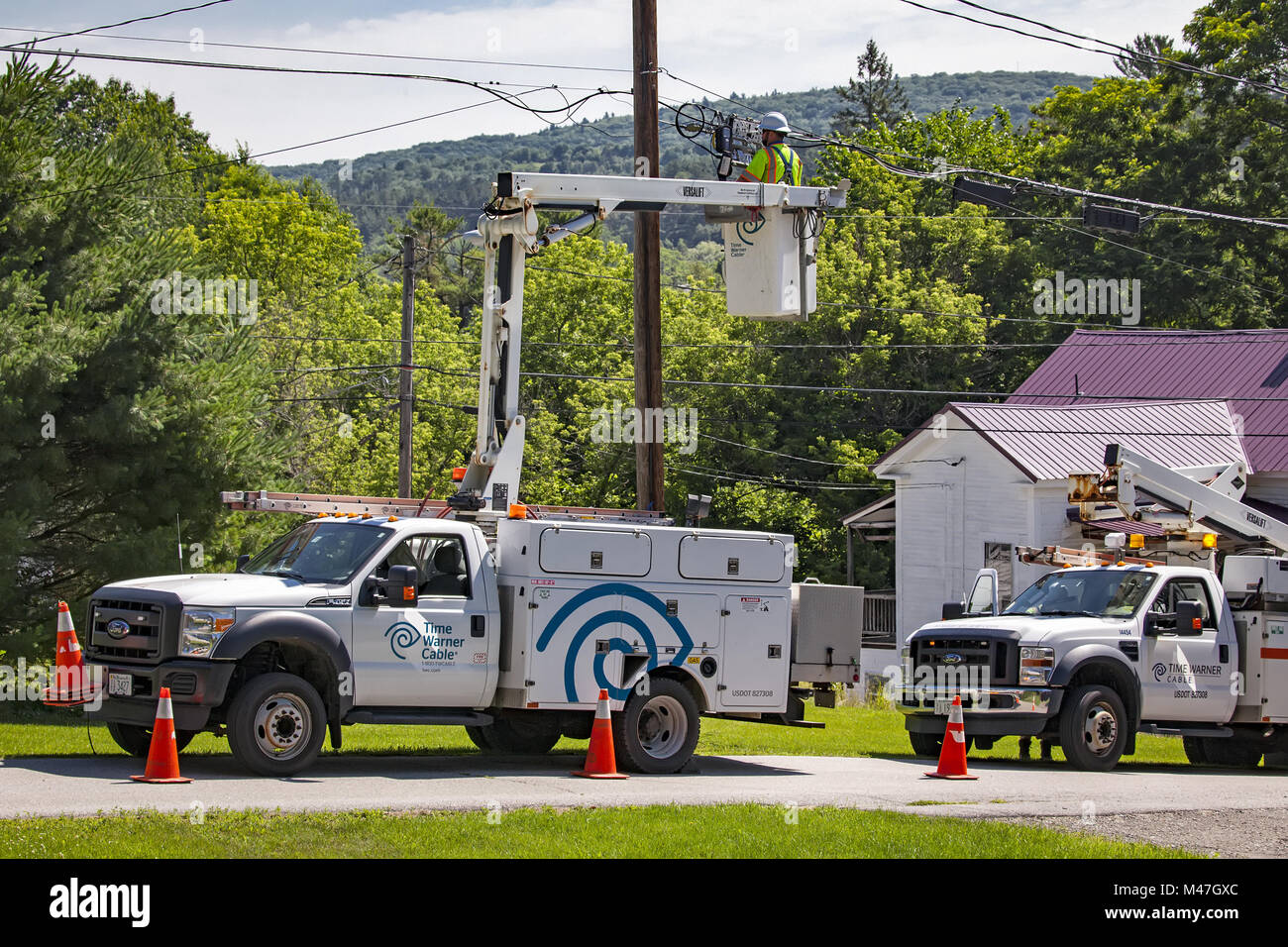 Power line worker fixing electrical connections. Stock Photo