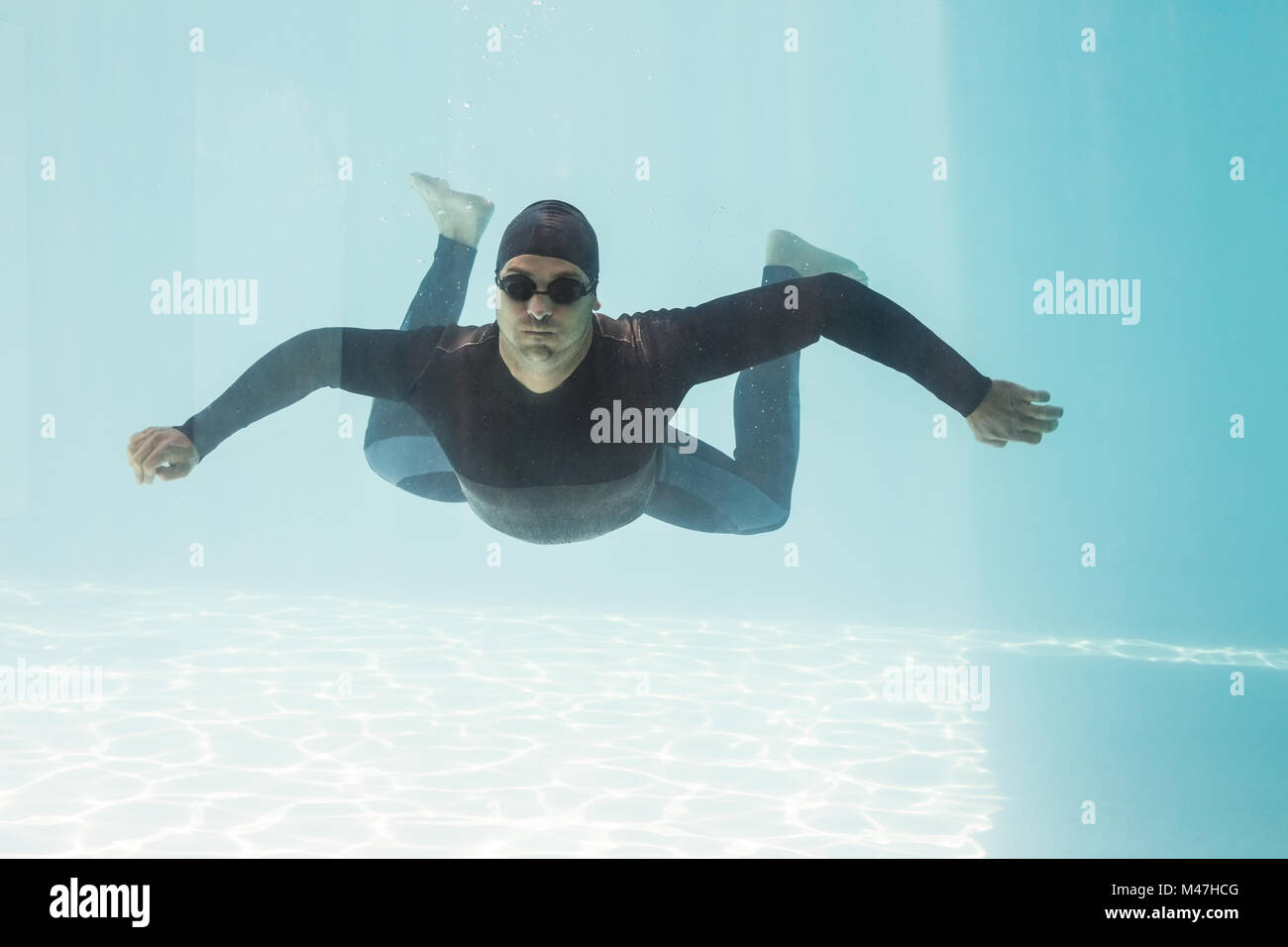 Young man with arms outstretched while swimming Stock Photo Alamy