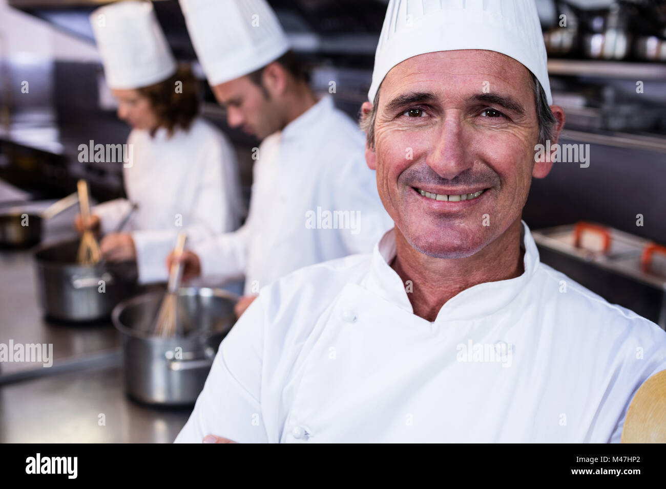 Portrait of smiling chef in commercial kitchen Stock Photo Alamy