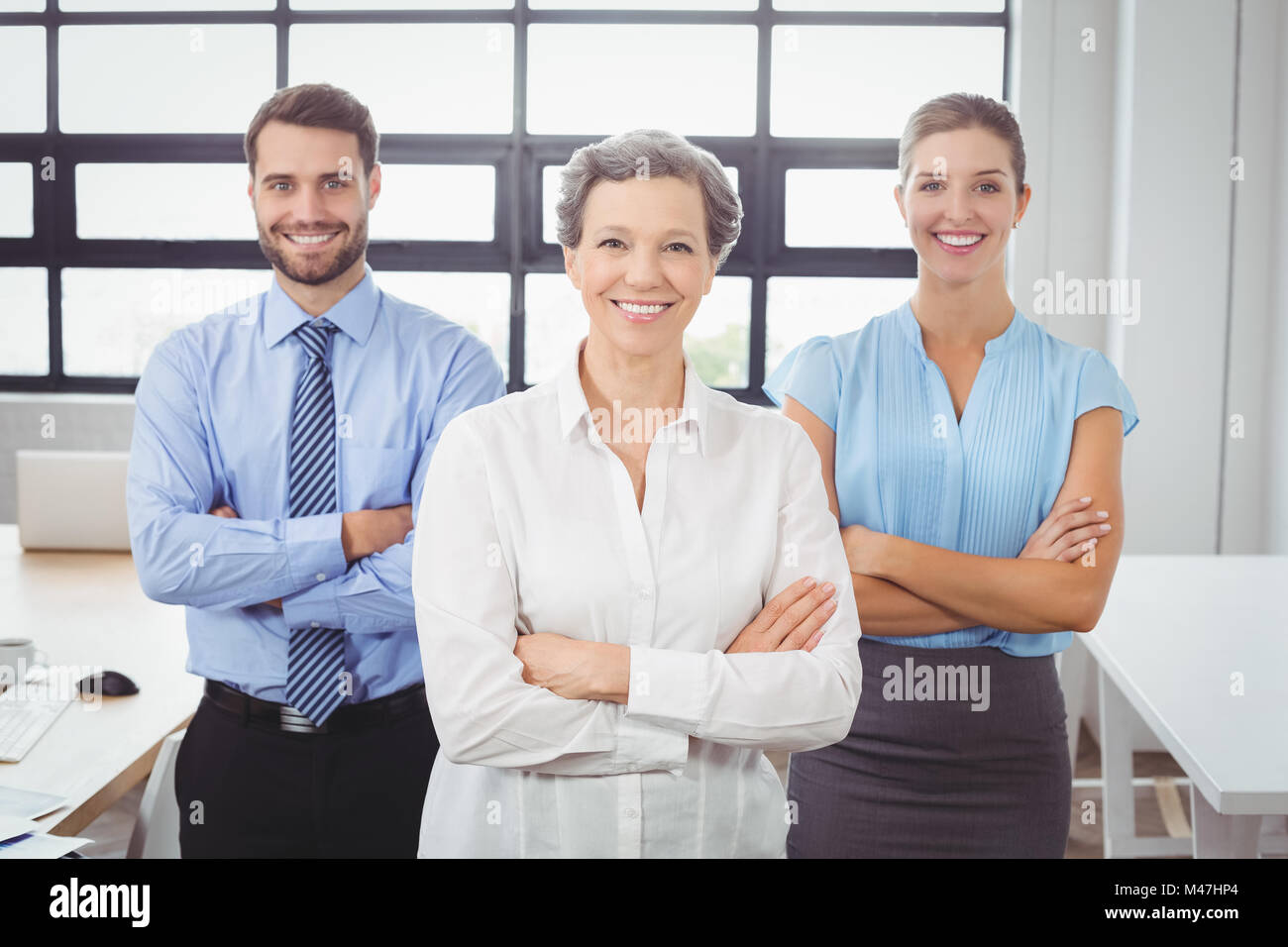 Confident business people with arms crossed in office Stock Photo - Alamy