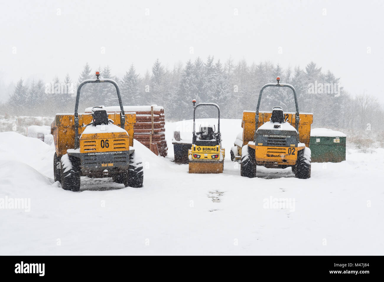 house building groundworks machinery on site in winter - UK Stock Photo