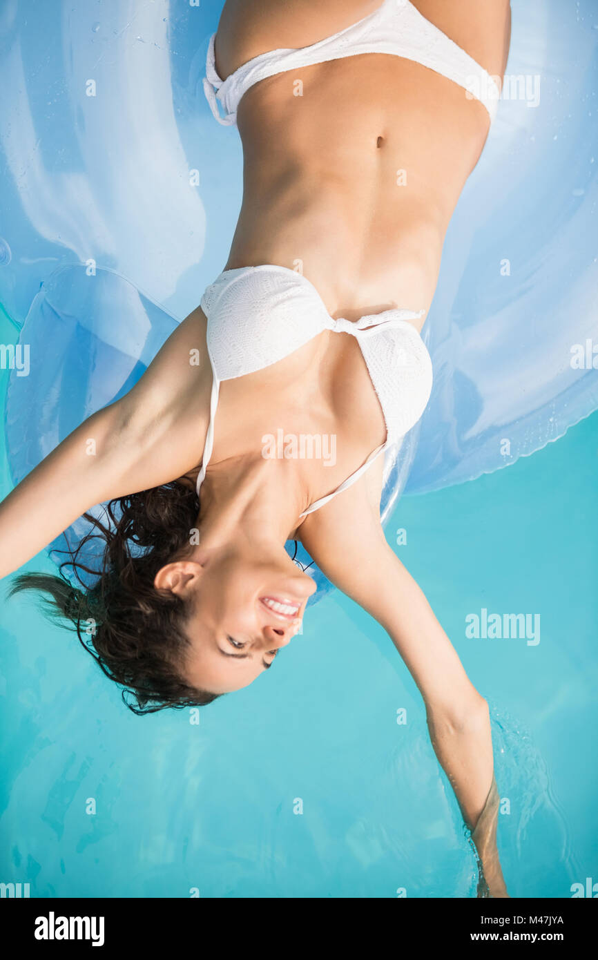 Pretty young woman relaxing on inflatable ring Stock Photo