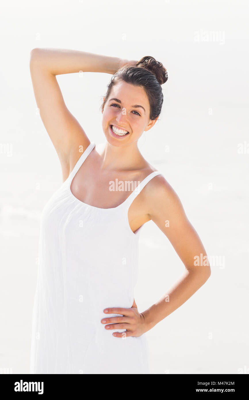 Happy woman in white outfit standing on the beach Stock Photo - Alamy