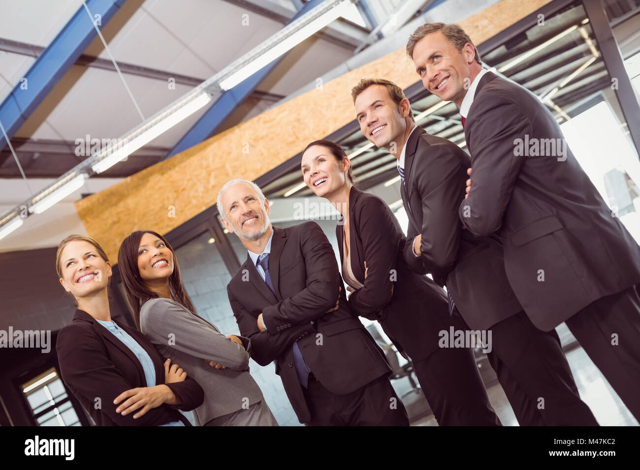 Businesspeople standing together with arms crossed Stock Photo - Alamy
