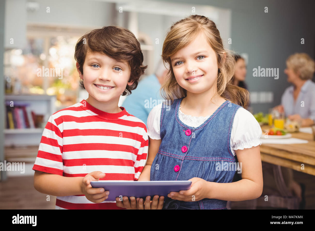 Portrait of brother and sister using digital tablet Stock Photo - Alamy