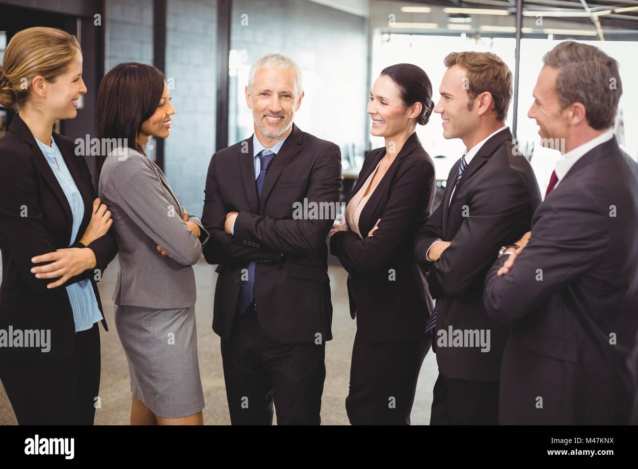 Businesspeople standing together with arms crossed Stock Photo - Alamy
