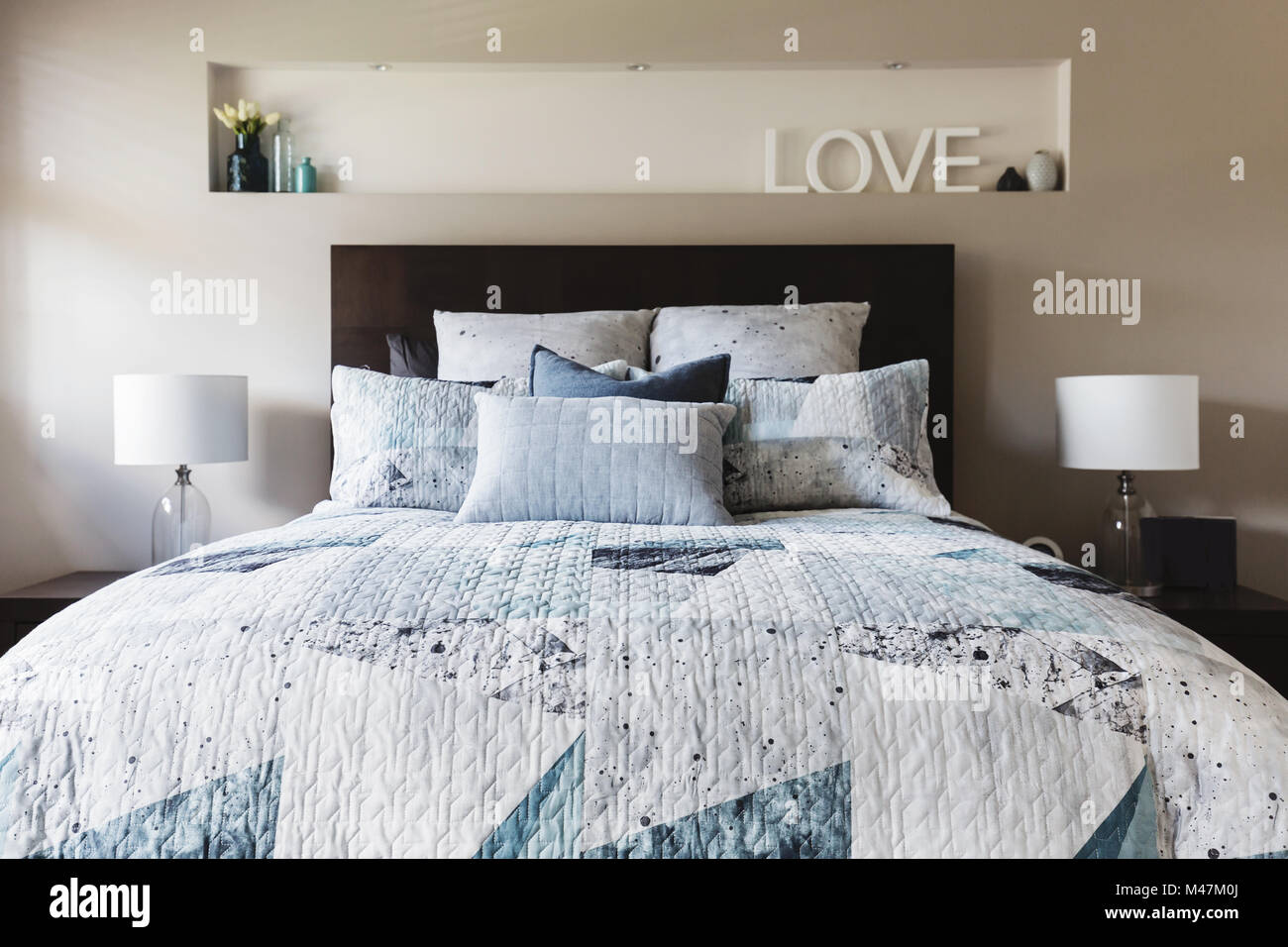 Master bedroom with contemporary quilt duvet and pillows Stock Photo
