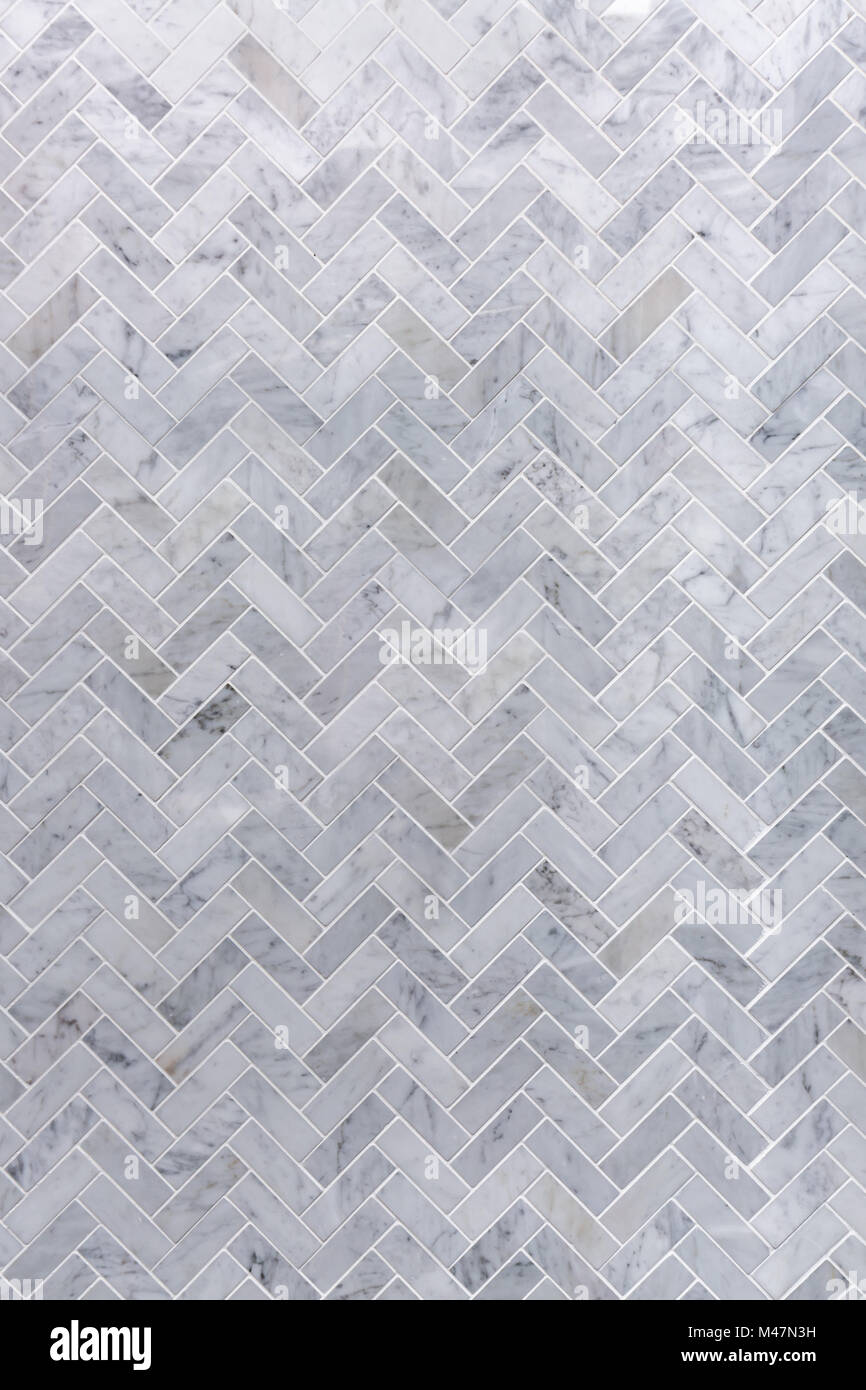 Background of grey and white marble tile in herringbone pattern Stock Photo
