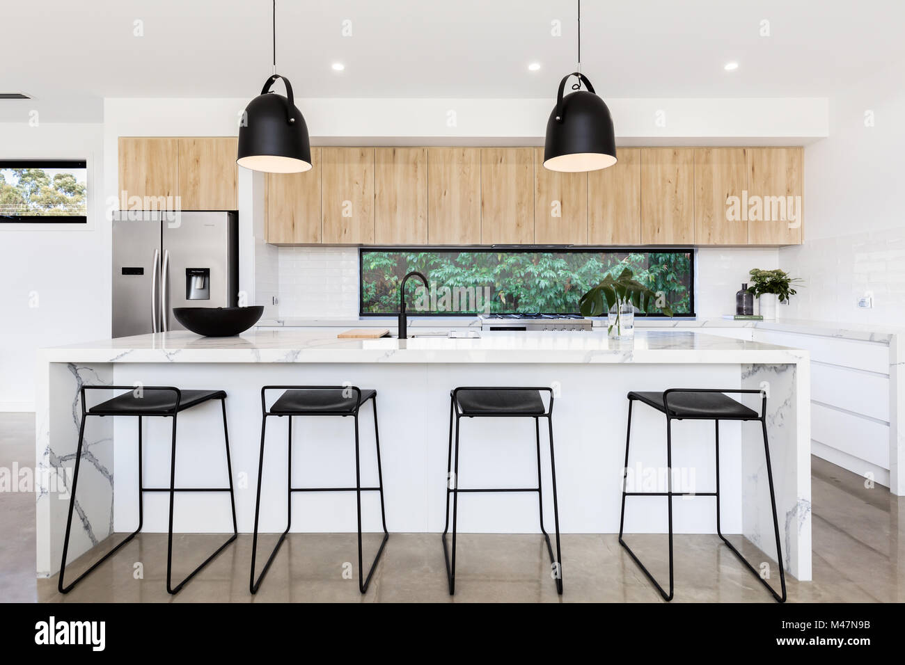 Large luxury Australian kitchen with marble island bench Stock Photo