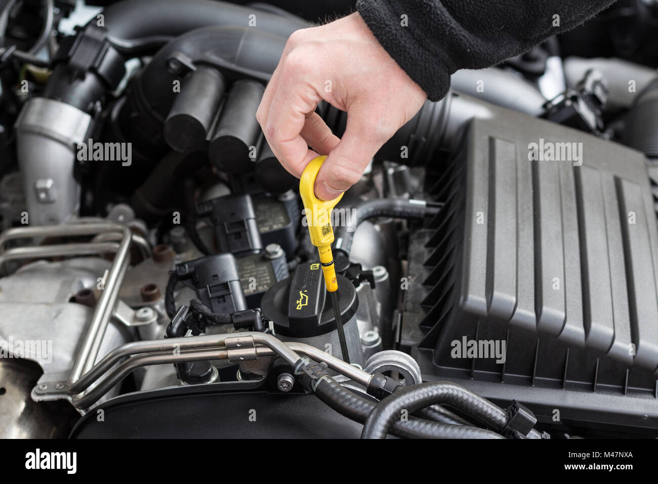 hand checking oil dip stick in modern car motor Stock Photo ...