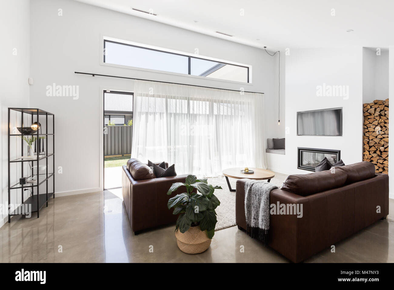 Modern open plan luxury living room with glass sliding doors Stock Photo