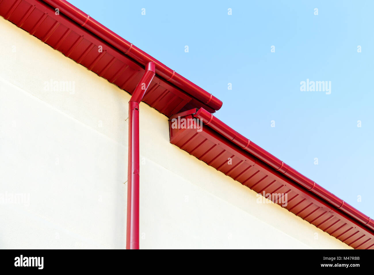 red rain gutter system on rooftop Stock Photo
