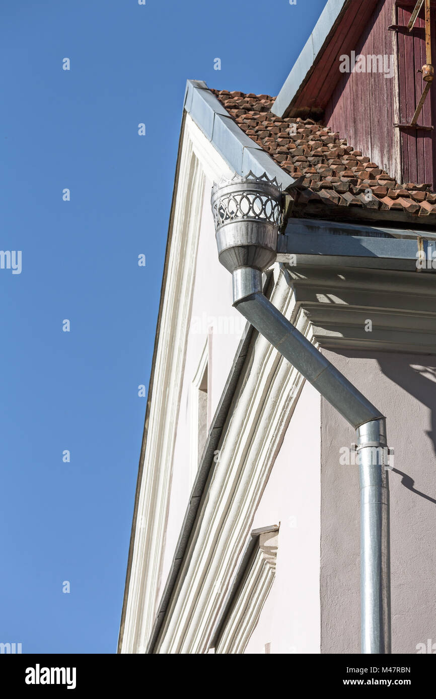 old downspout on wall of building Stock Photo