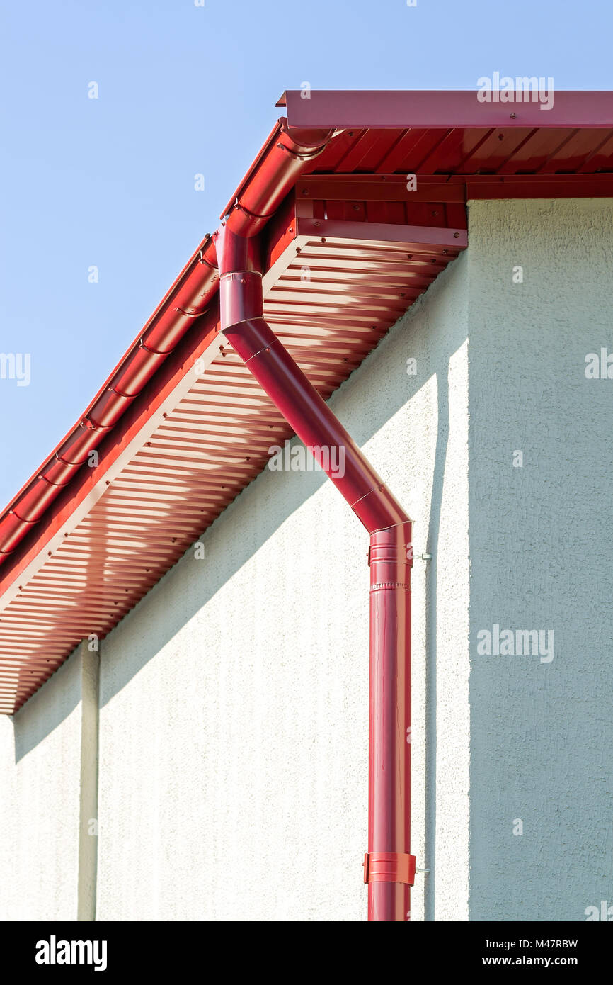 red roof gutter on house facade Stock Photo