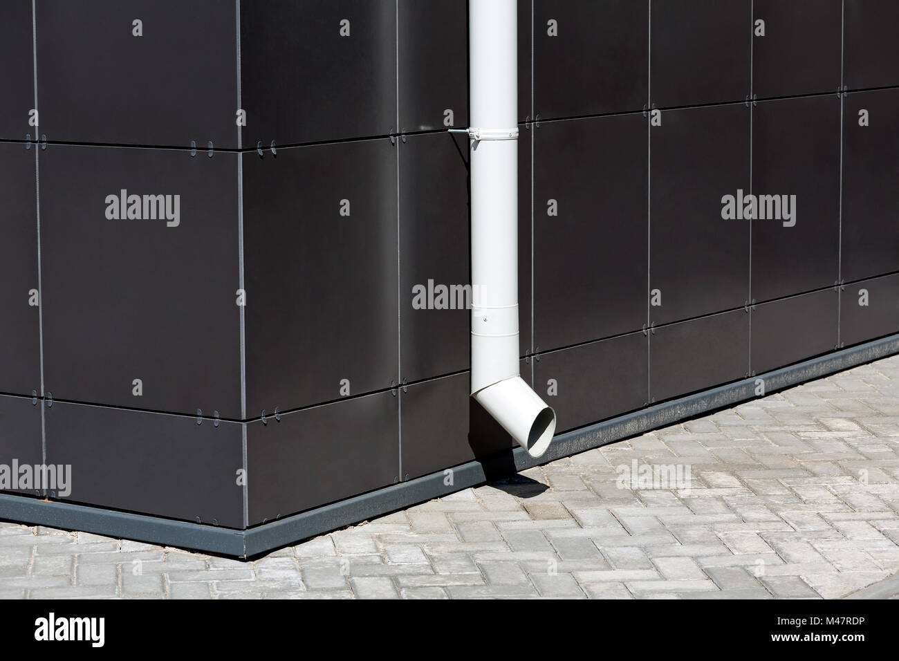 white downspout on dark building facade Stock Photo Alamy