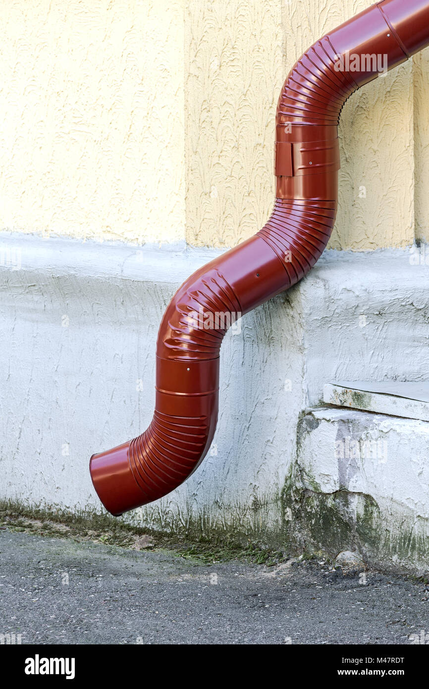 red curved downspout Stock Photo