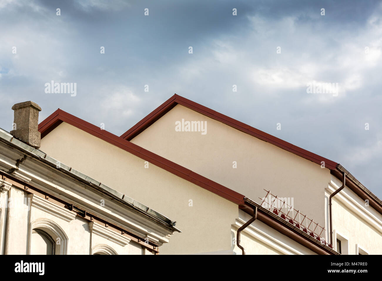 old houses with red roof under cloudy sky Stock Photo
