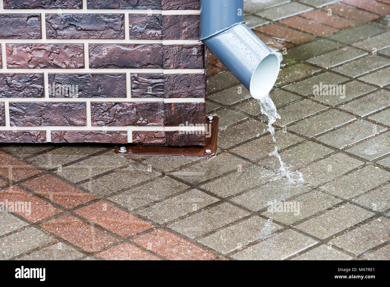 rain water flowing from a downspout Stock Photo