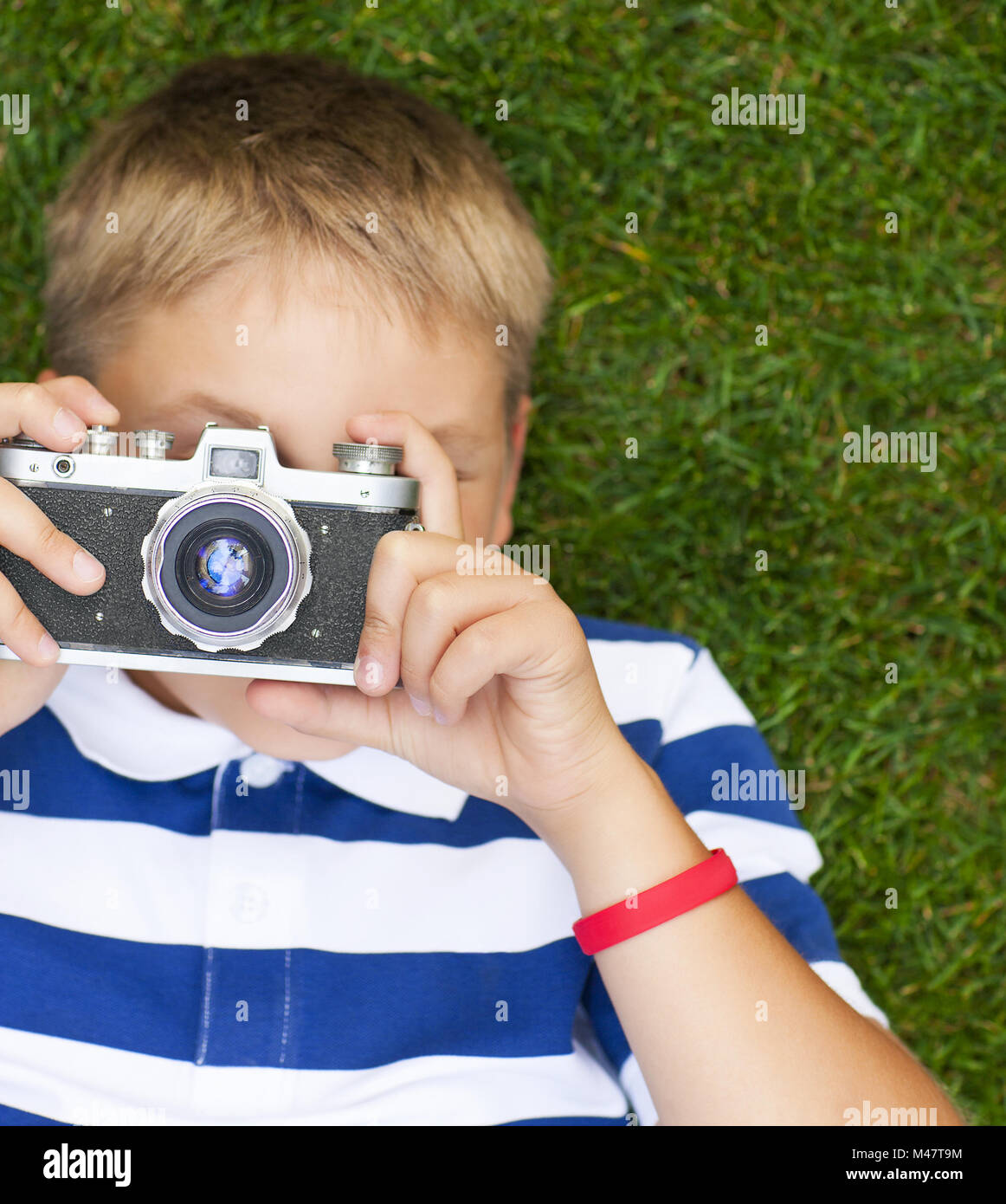 Happy smiling little boy with retro vintage camera Stock Photo