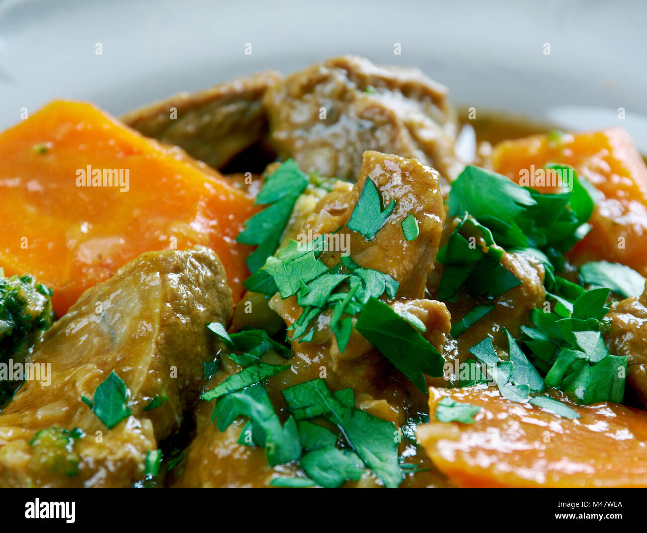 German traditional beef stew with carrots, dark beer Stock Photo Alamy
